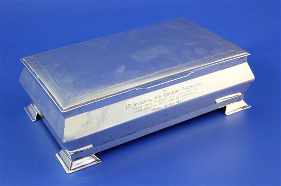 A George V engine turned silver cigarette box with later inscription relating to Lt.General Sir Gordon Macready, gross 41 oz.